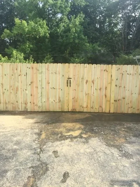 New wooden privacy fence with vertical boards and black gate hardware in Deltona