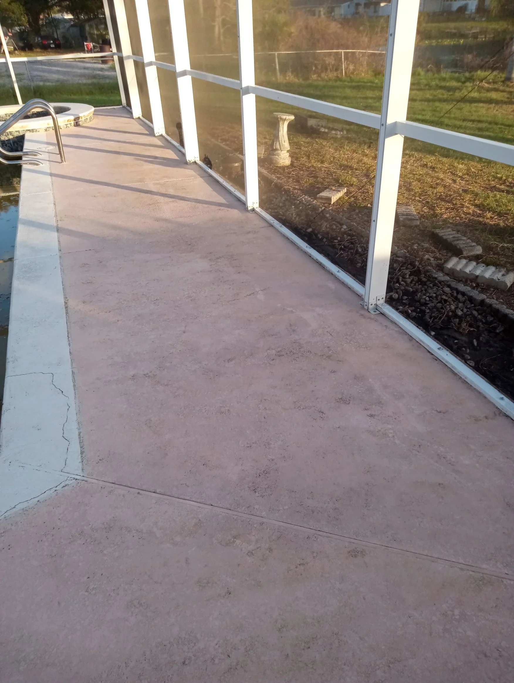 White aluminum screen porch enclosure with concrete floor and full screening panels